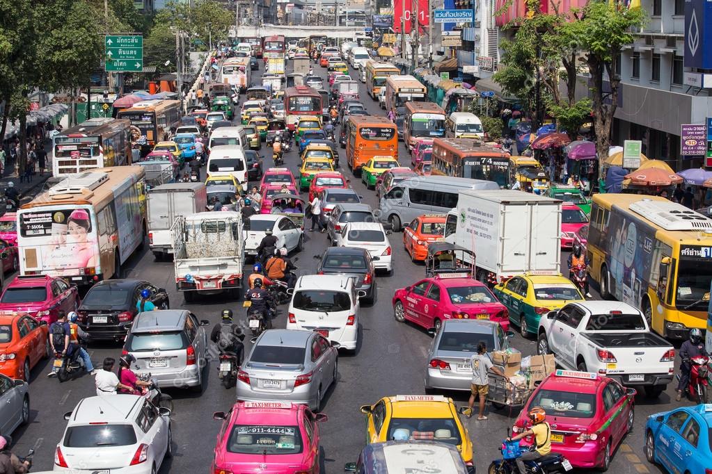 Traffic moves slowly along a busy road in Bangkok, Thailand. Stock