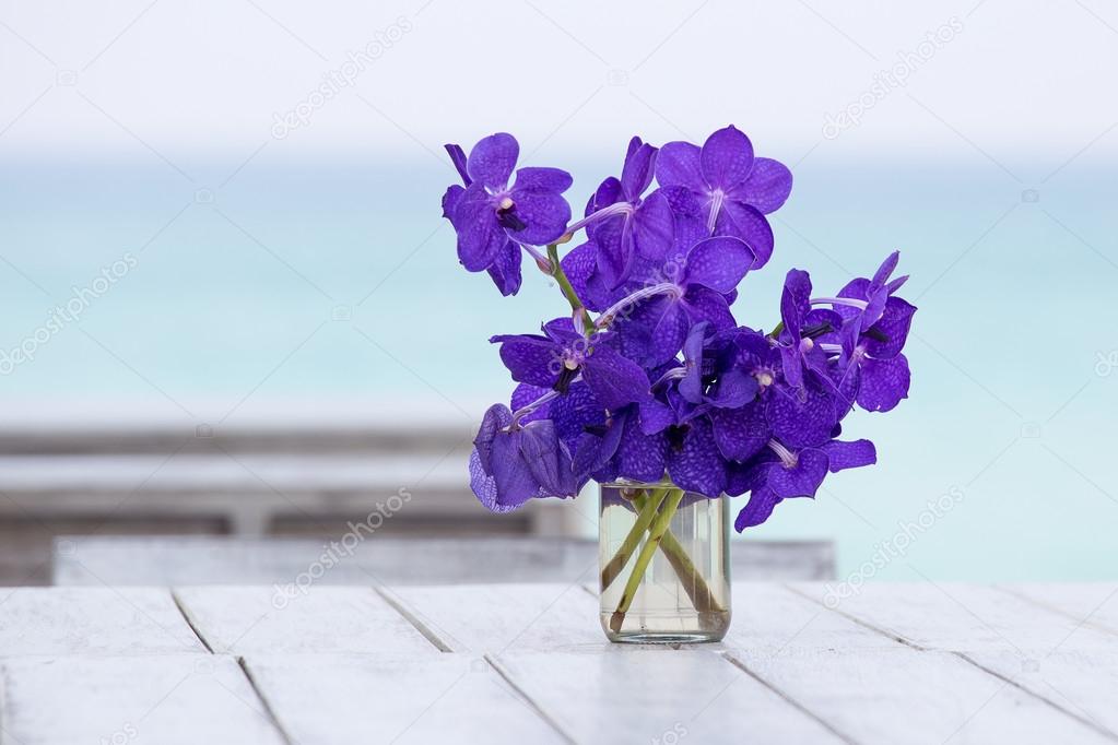 Bouquet orchids flower on a background of the sea in table