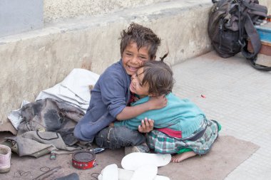 Beggar boy and girl in Leh, India clipart