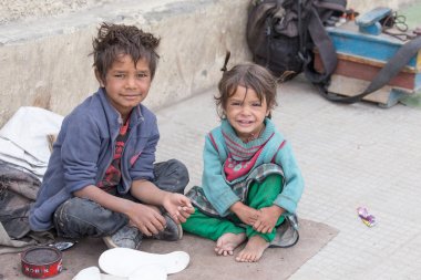 Beggar boy and girl in Leh, India clipart