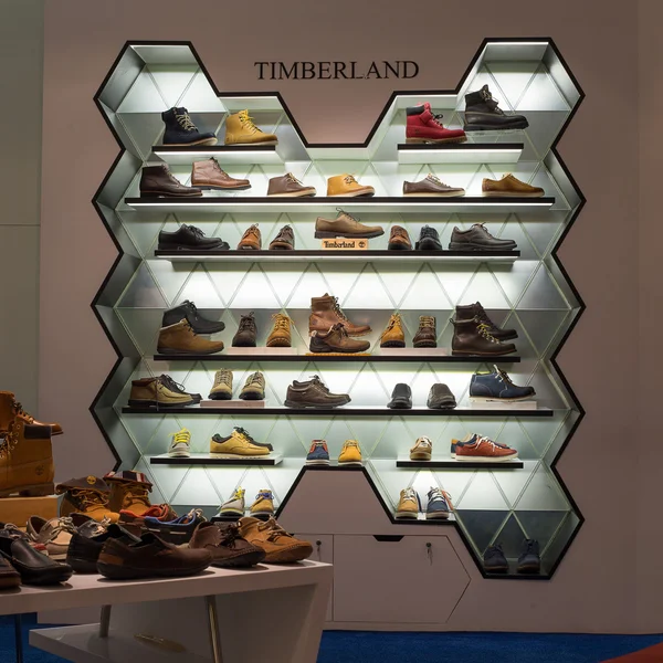 Lot shoes brand name - Timberland on a glass shelf at the Siam Paragon Mall. Siam Paragon is a one of the biggest shopping centres in Asia.