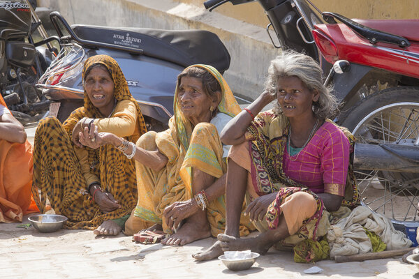 Beggars indian women waits for alms on a street in Pushkar, India