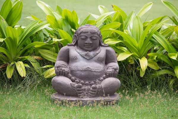 Traditional stone sculpture in garden .  Bali, Indonesia