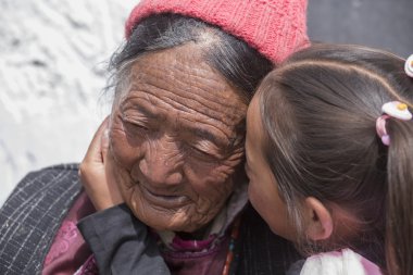 Tibetan Buddhist old women and children in Hemis monastery. Ladakh, North India