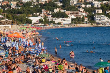 People are relaxing on the beach in Sutomore, Montenegro