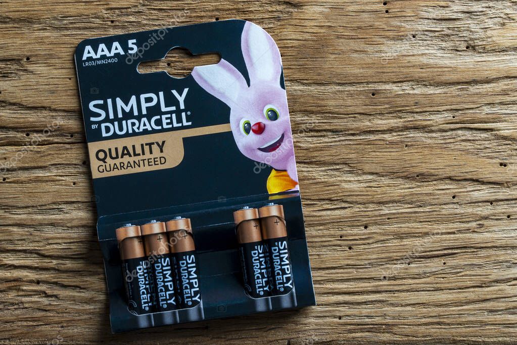 Kyiv, Ukraine - Oct 05, 2025 : Duracell alkaline batteries in paper package on wooden background, closeup. Duracell is an American brand product line of batteries, owned by Berkshire Hathaway, NE, USA