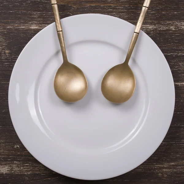 Facial image on the plate with spoons — Stock Photo, Image