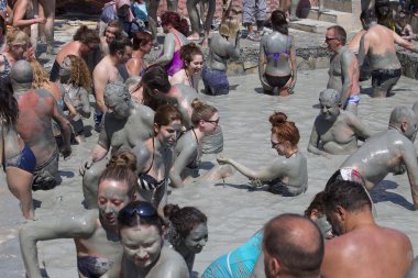 People are taking a mud bath. Mud baths are great for the skin. Dalyan, Turkey