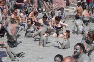 People are taking a mud bath. Mud baths are great for the skin. Dalyan, Turkey