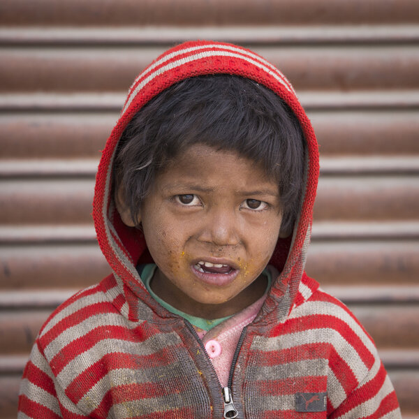 Portrait Indian beggar boy on street in Leh, Ladakh, India