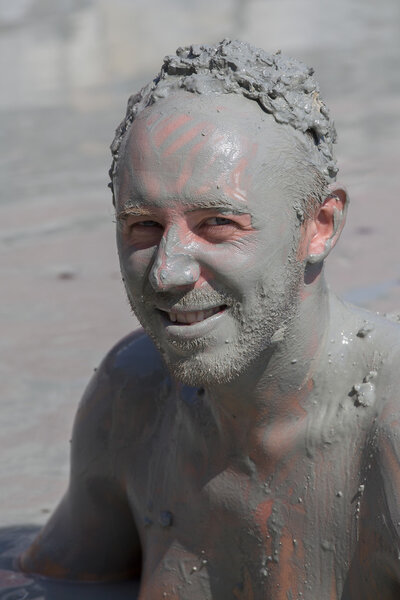 Portrait happy man who takes a mud bath. Dalyan, Turkey