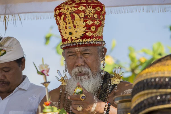 El viejo Brahmin lleva a cabo un ritual religioso en la playa Ketewel. Ubud, Bali, Indonesia — Foto de Stock