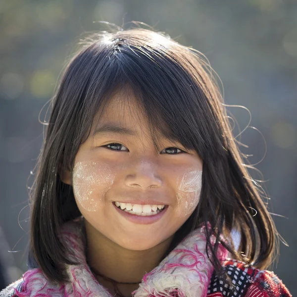 Portrait young girl with thanaka on her smile face. Inle lake, Myanmar — Stock Photo, Image