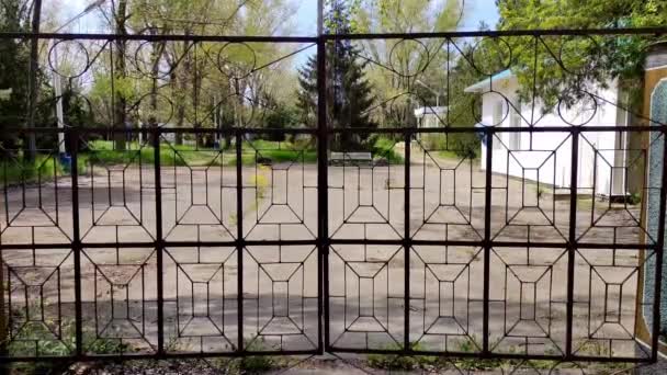 Metal transparent gate in an abandoned area — Stock Video