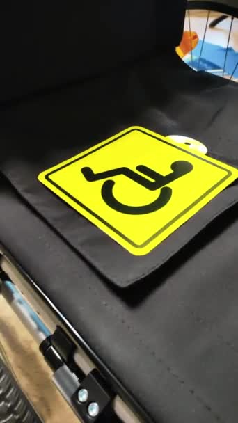 Disabled sign lies in a wheelchair in a rehabilitation center — Stock Video