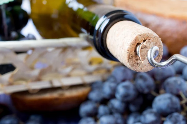 Corkscrew in the cork and the bottle — Stock Photo, Image