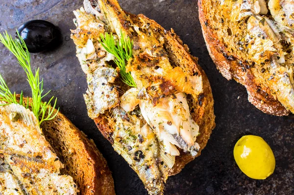 Sandwiches, tapas with grilled fish — Stock Photo, Image