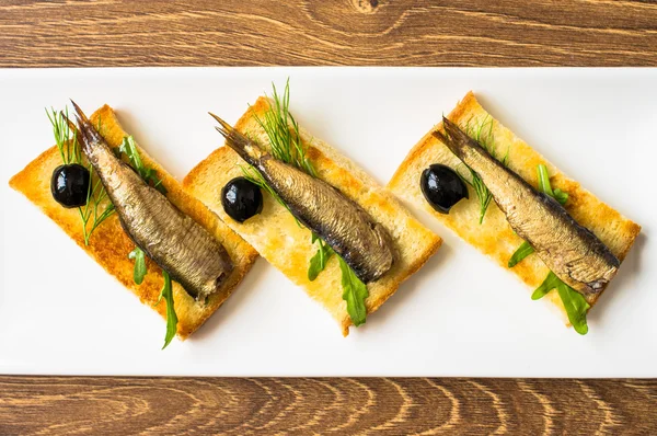 Smoked sardines on toast — Stock Photo, Image