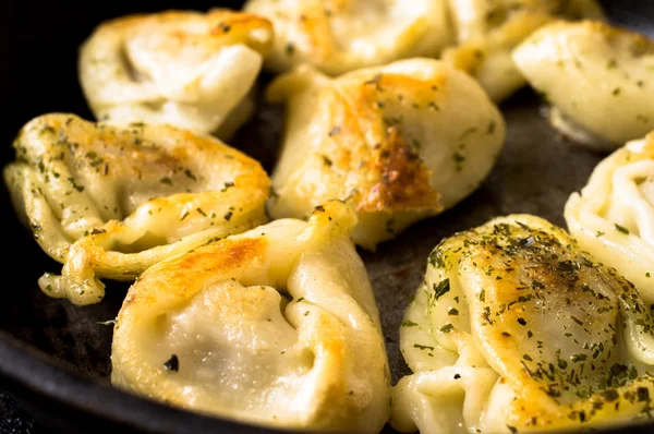 Fried dumplings with beef on rustic pan — Stock Photo, Image