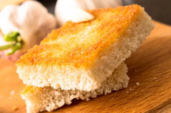 Garlic bread on a wooden table — Stock Photo, Image