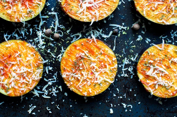 Snack slices eggplant with cheese on a baking sheet — Stock Photo, Image