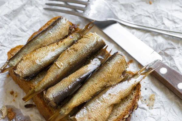 Sandwich with sprats in a rustic style — Stock Photo, Image