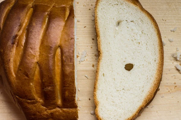 Cut off a piece of loaf bread — Stock Photo, Image