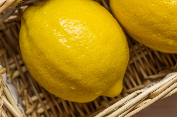 Fresh lemons in a basket — Stock Photo, Image