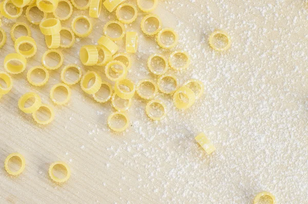 Pasta anellini rings in flour — Stock Photo, Image