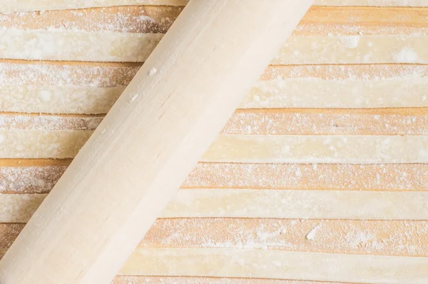 Cooking pasta rolling pin on the table — Stock Photo, Image