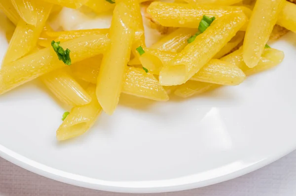Fried penne pasta on a white plate — Stock Photo, Image