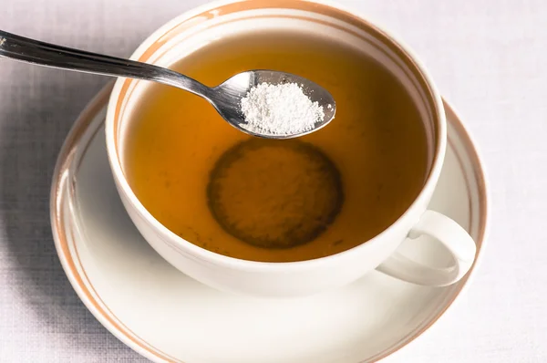 Tea with sweetener in a spoon — Stock Photo, Image