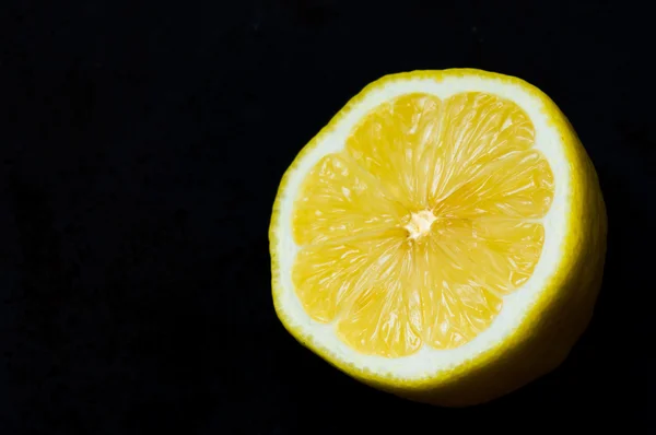 Half of lemon on a black background — Stock Photo, Image