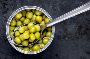 Bir kaşık ile yeşil bezelye teneke konserve