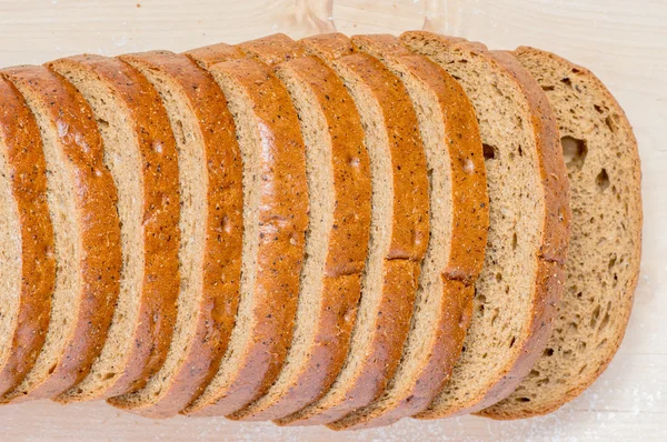 Loaf rye bread, cut into pieces — Stock Photo, Image