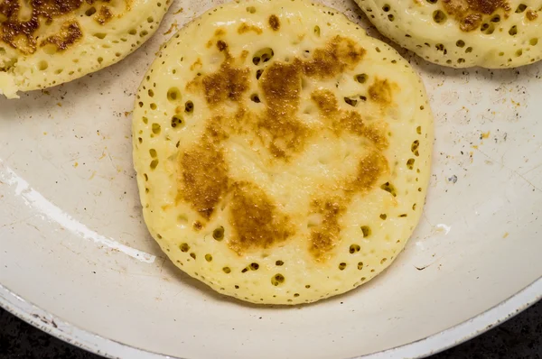 Fried pancakes frying pan on a white — Stock Photo, Image