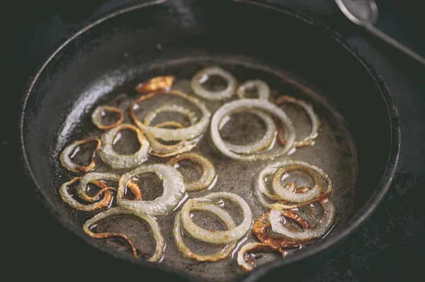 Fry in black skillet white onion Stock Picture
