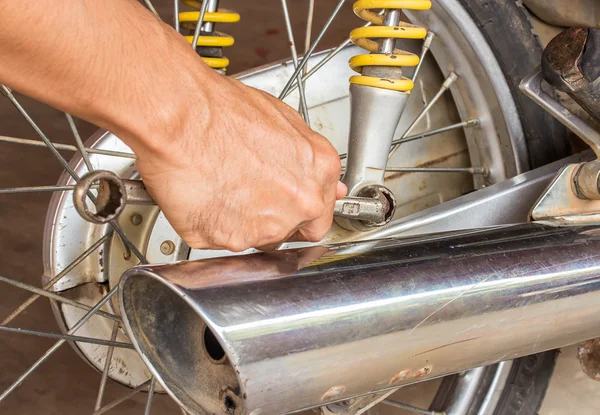 Chave de mão segurando com reparação de motocicleta — Fotografia de Stock