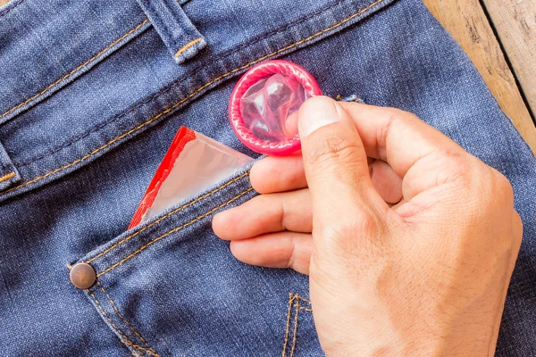 Condom in the blue jeans pocket — Stock Photo, Image