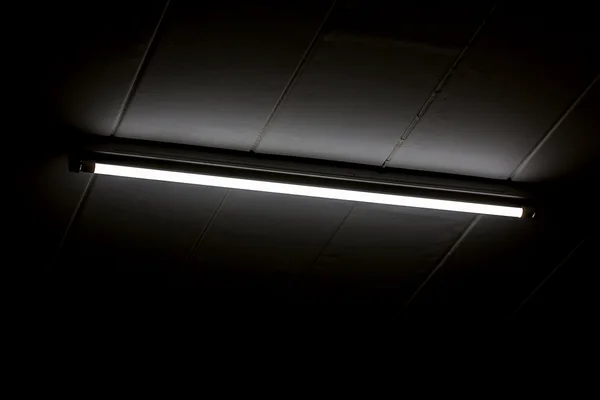 Detail of a fluorescent light tube mounted on a wall — Stock Photo, Image