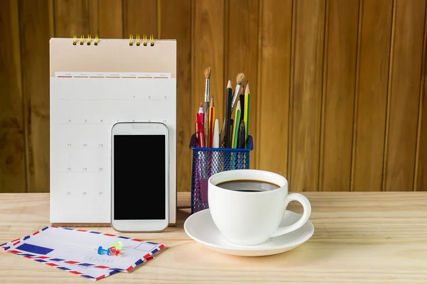 office supplies and coffee on wooden table
