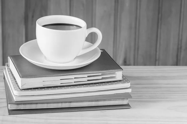 Cup of coffee and book on wooden table — Stock Photo, Image