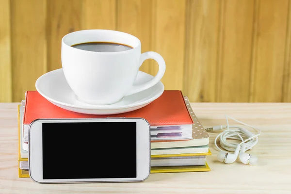 Smart phone and coffee on wooden table — Stock Photo, Image