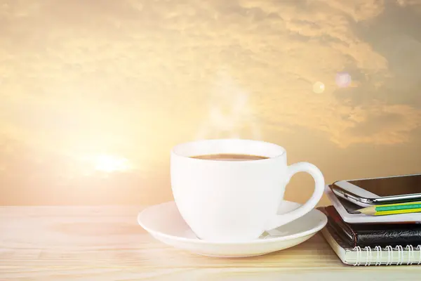 Coffee cup,smart phone and note book on wooden table — Stock Photo, Image