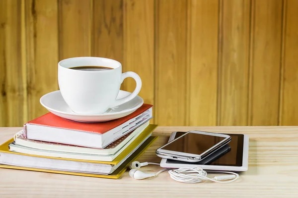 Smart phone,coffee cup,and stack of book on wooden table — Stock Photo, Image