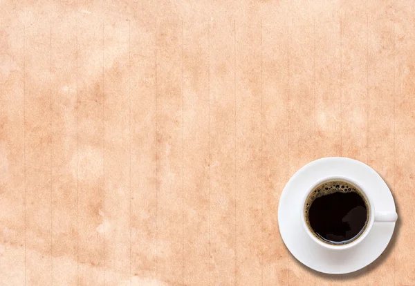 Cup of coffee in a white cup on paper texture — Stock Photo, Image