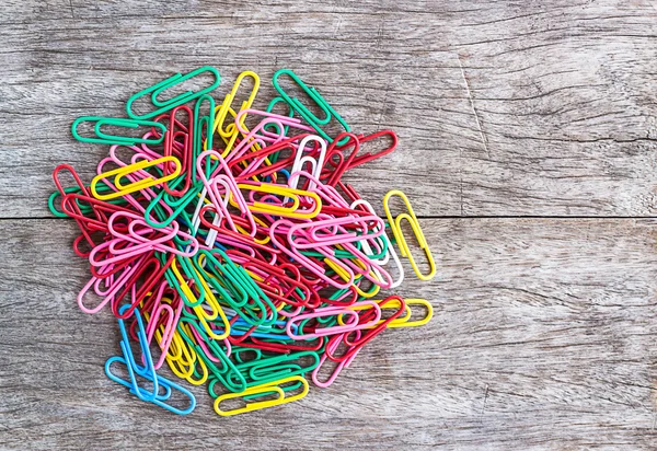 Colorful clips on wood background — Stock Photo, Image