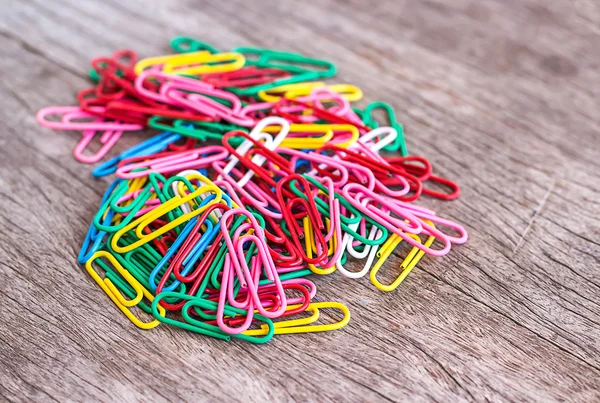 Colorful clips on wood background — Stock Photo, Image