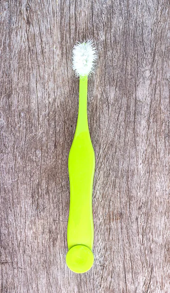 Old toothbrush on the wood background — Stock Photo, Image