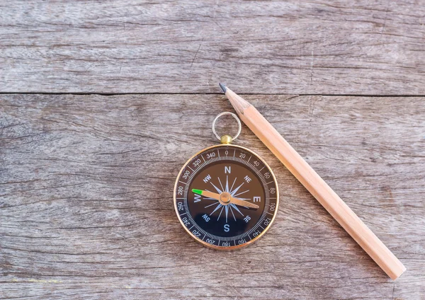 Pencil and compass over a wooden background — Stock Photo, Image